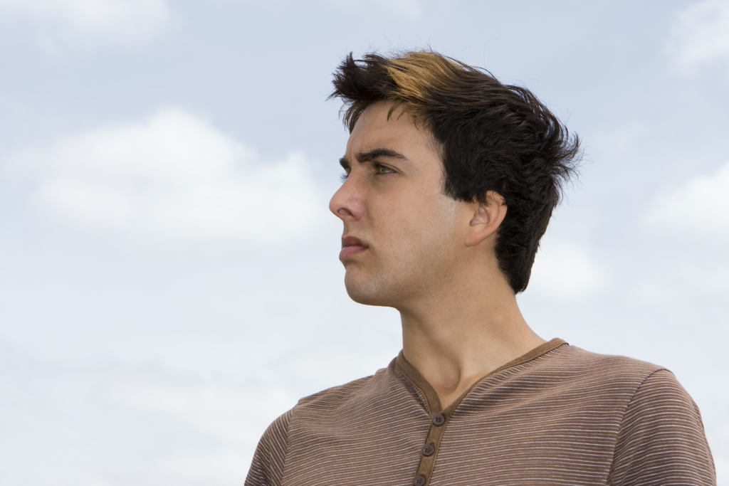 angry young man looking out at sky