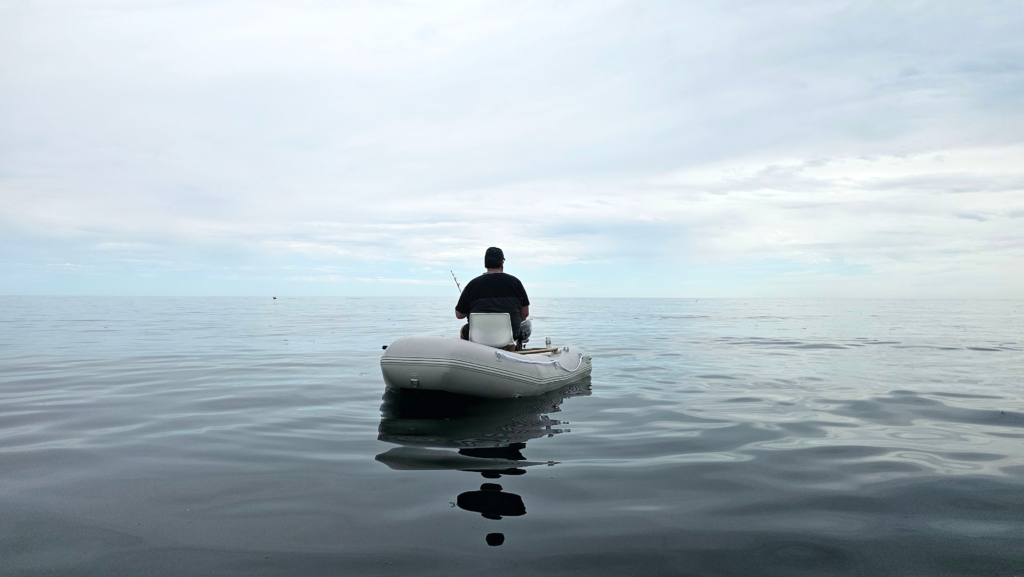 lone person on boat calm water