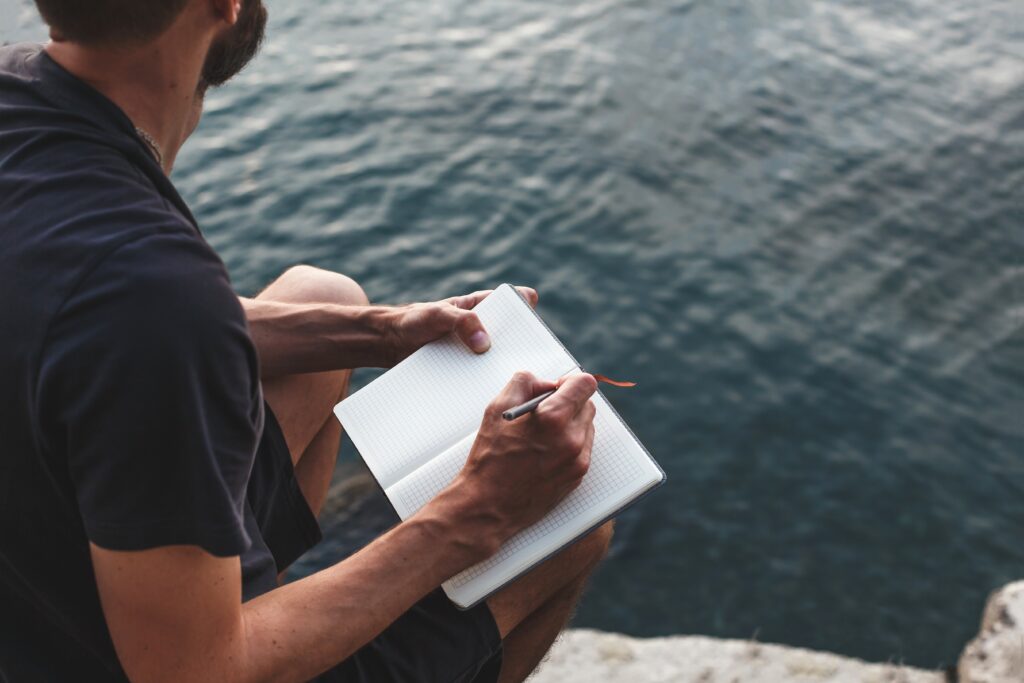 man taking notes on beach